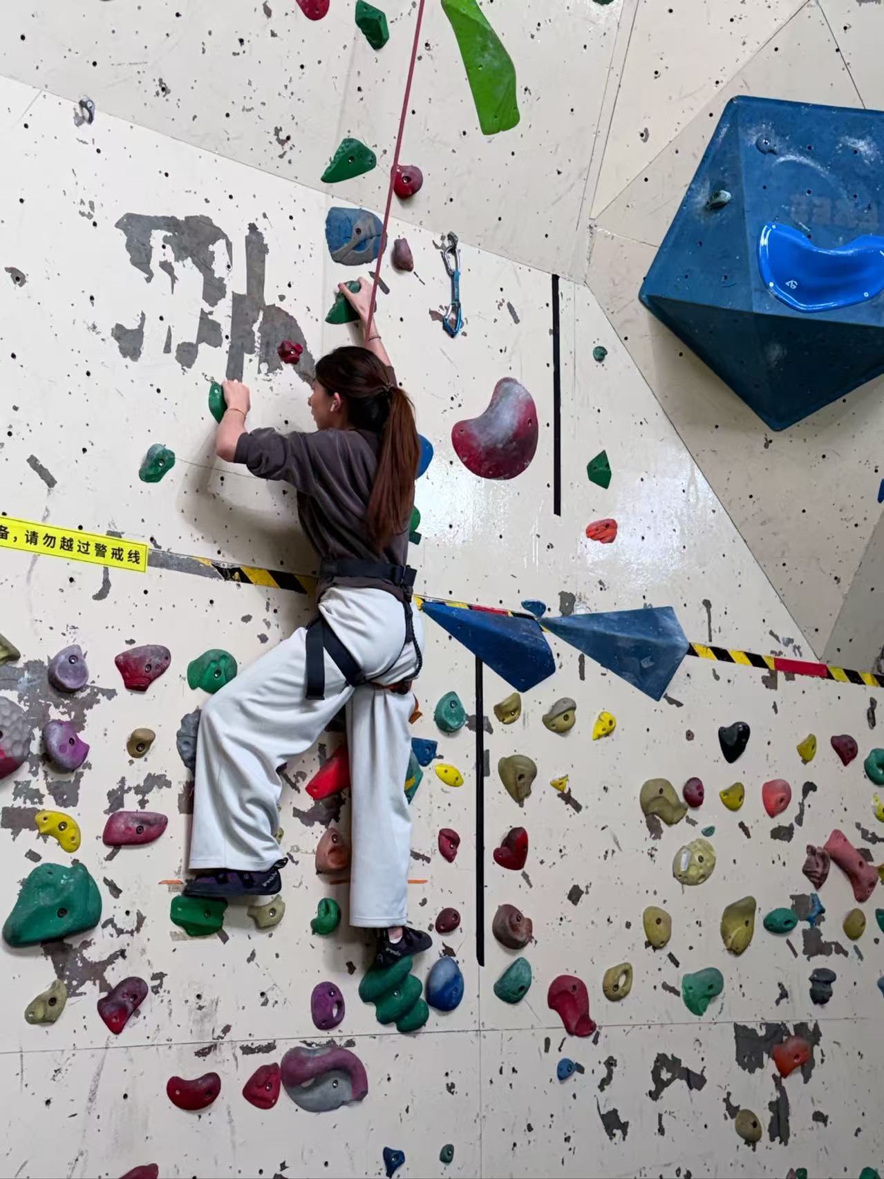 Participant climbing trial used to observe route following, uncertainty, and recovery needs on the wall.